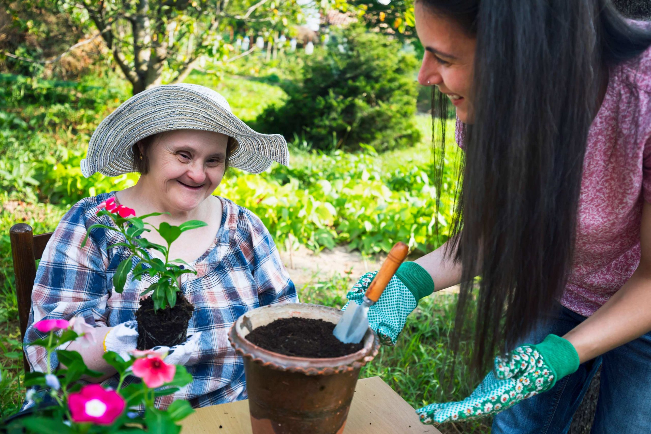 Disabled lady and support worker gardening