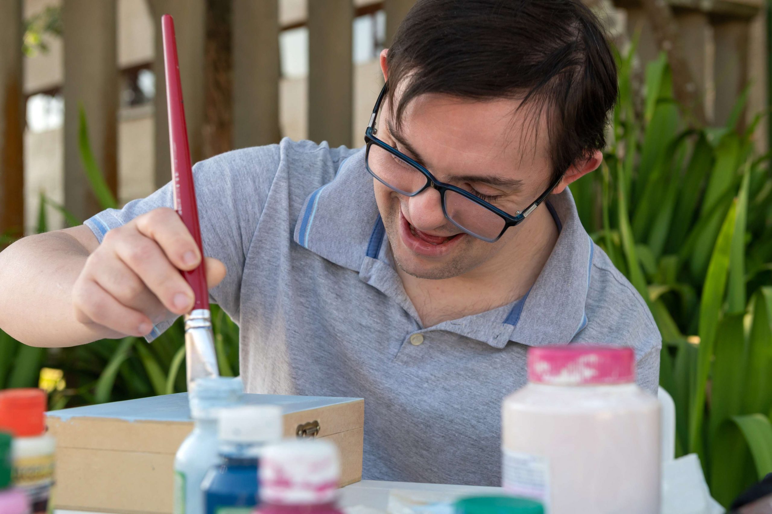 Man with disability painting a craft project
