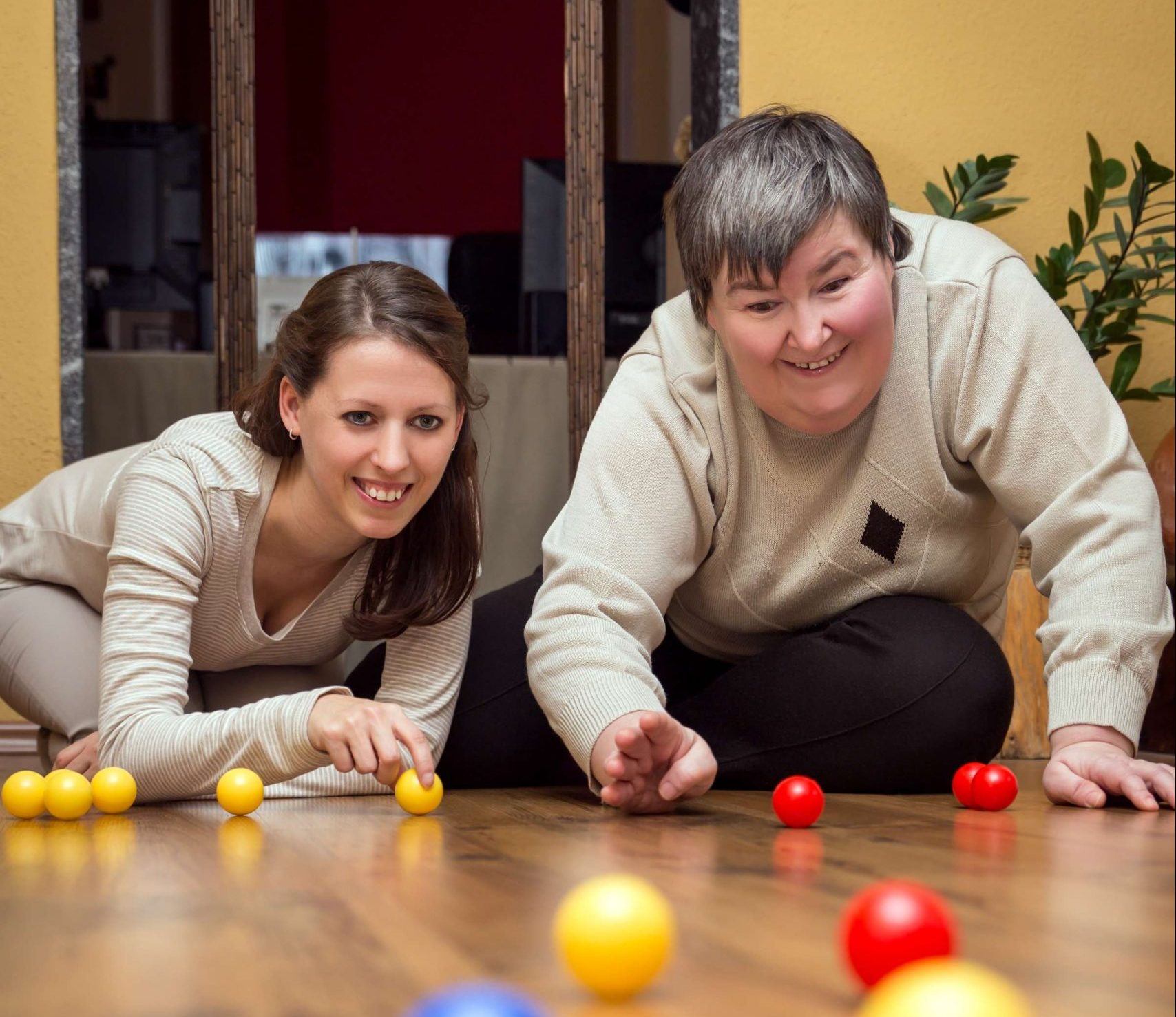 Woman with disability playing game with support worker